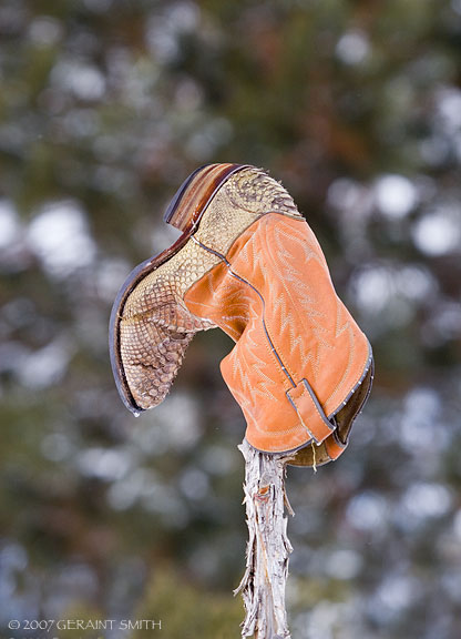 Cowboy boot on a fence in Taos, NM