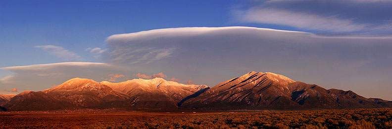 Mesa, mountains and winter light taken from Hwy 64 near the Rio Grande Gorge Taos, New Mexico