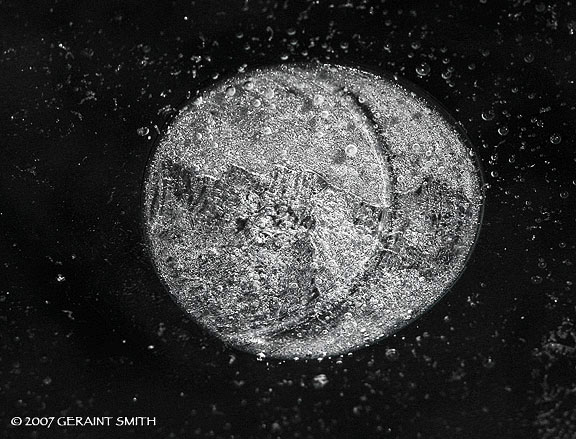 In the a parking lot puddle ... ice moon