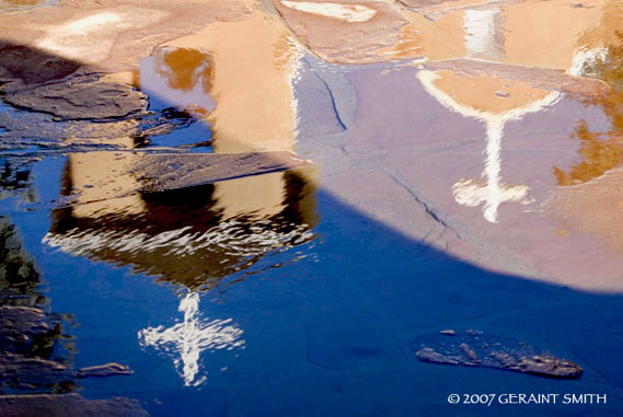 Reflections in the snow melt at the St Francis church Ranchos de Taos, NM