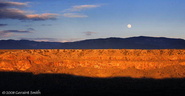 Full moon rise over the Rio Grande Gorge rim 