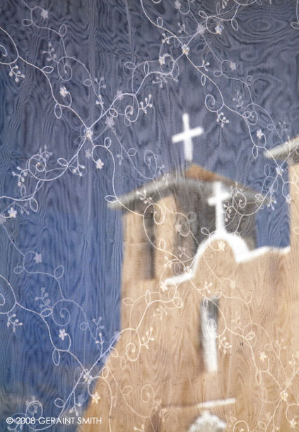 St Francis reflections in a window of lace in Ranchos de Taos
