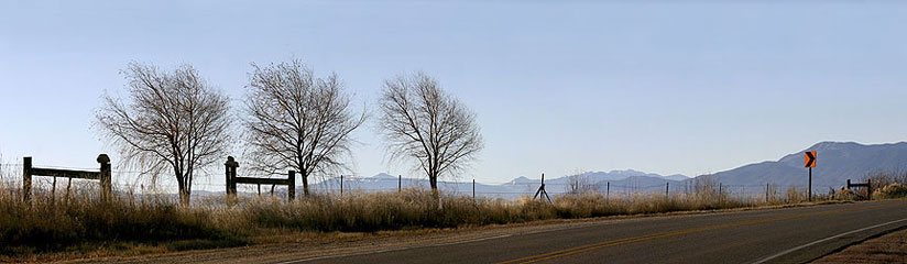 Rocks, fence, trees, sign, Arroyo Seco, NM