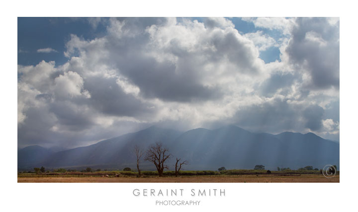 Morning light rays over Taos Mountain on the drive in to town ... always a good commute