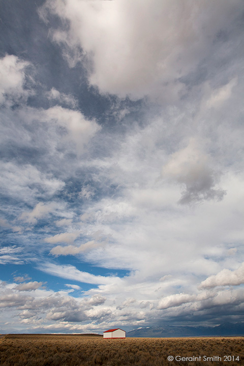 Red and white on the mesa with mountain clouds taos new mexico