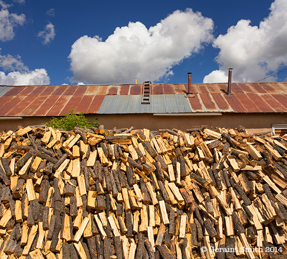 Wood pile as big as house on the high road to Taos truchas new mexico