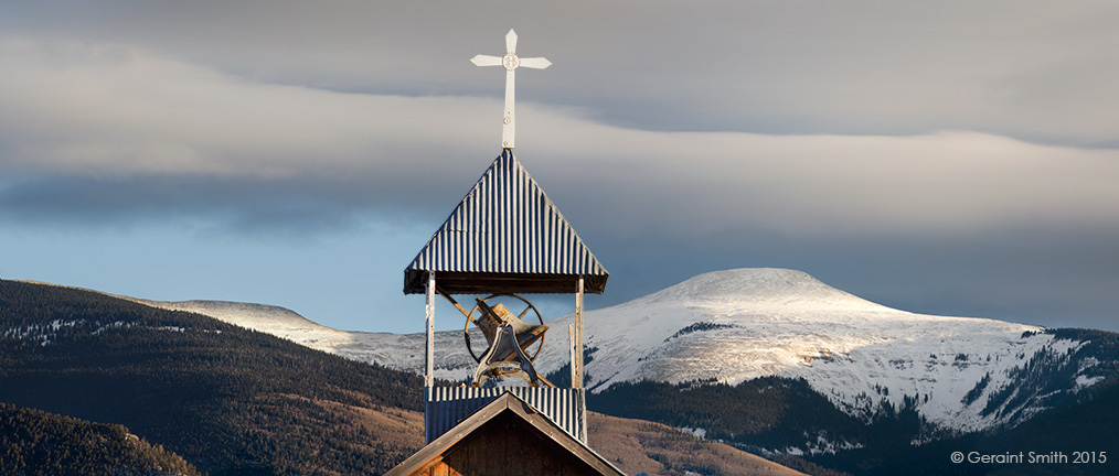 The church belfry in Llano de San Juan with a backdrop of Jicarita peak, on the High Road to Taos