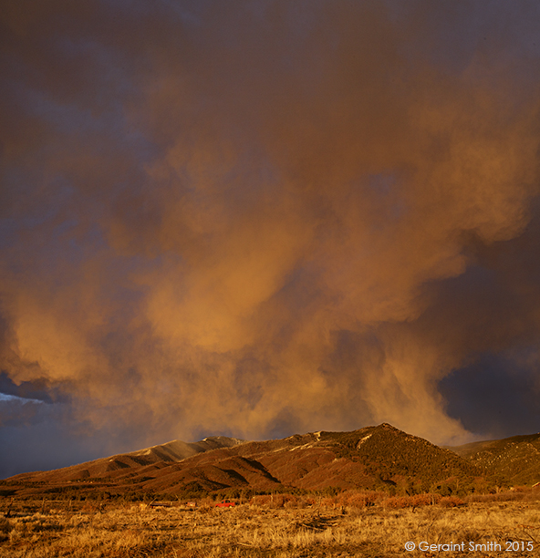 Red truck under a Spring squall over the Sangre de Cristos