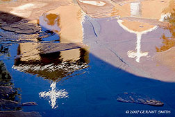 2007 November 25, Reflections in the snow melt at the St Francis church Ranchos de Taos, NM