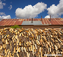 2014 September 29  Wood pile as big as house on the high road to Taos truchas nm
