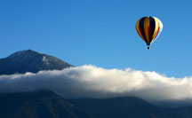 Balloon rise, and cloud over Taos Mountain, New Mexico